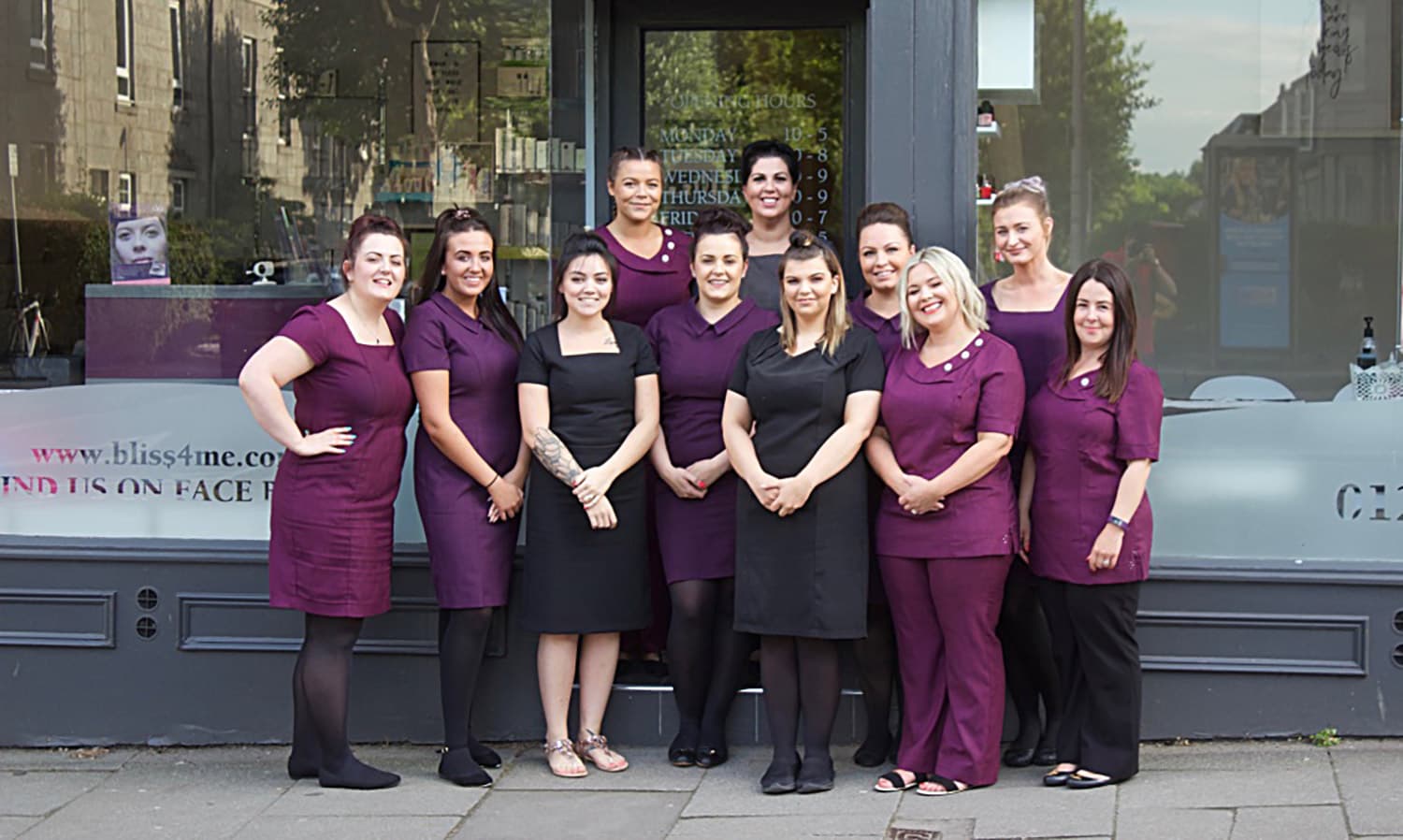 beauty salon women posing for a picture outside their salon